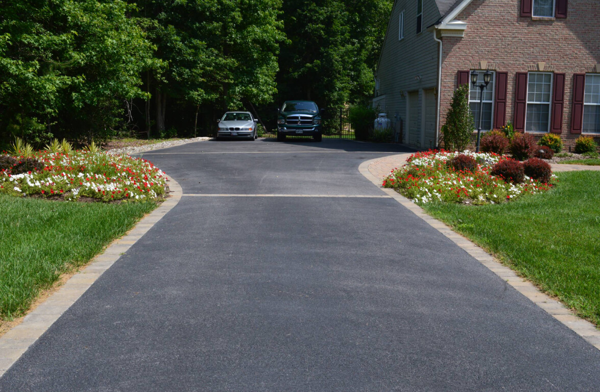 Professional concrete driveway with decorative landscaping in Champaign, IL