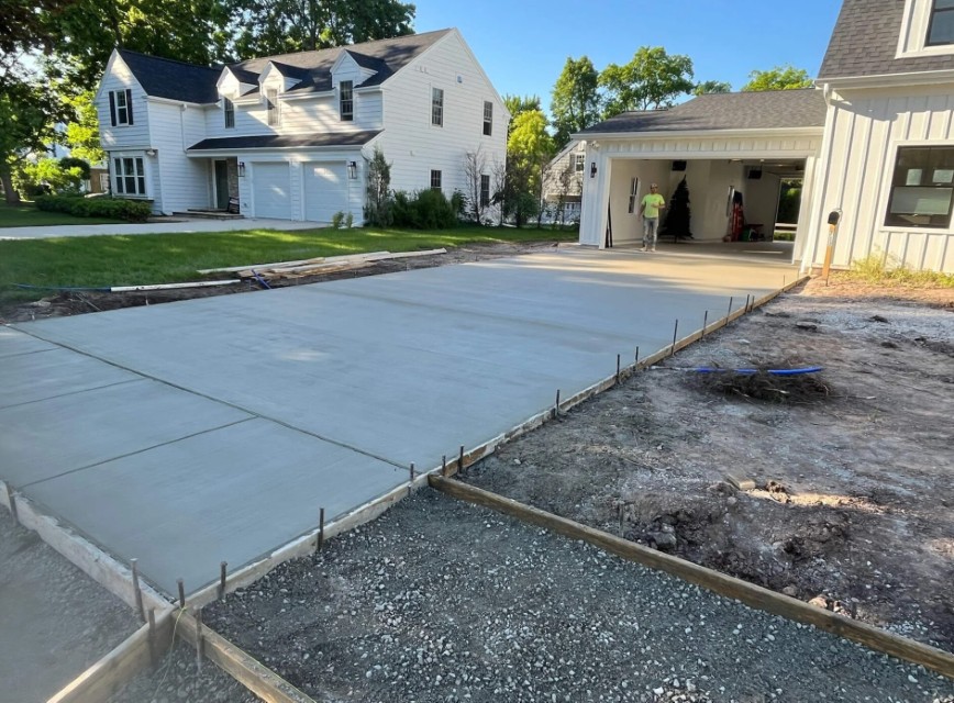 Freshly poured residential concrete driveway with professional finish in Champaign, IL